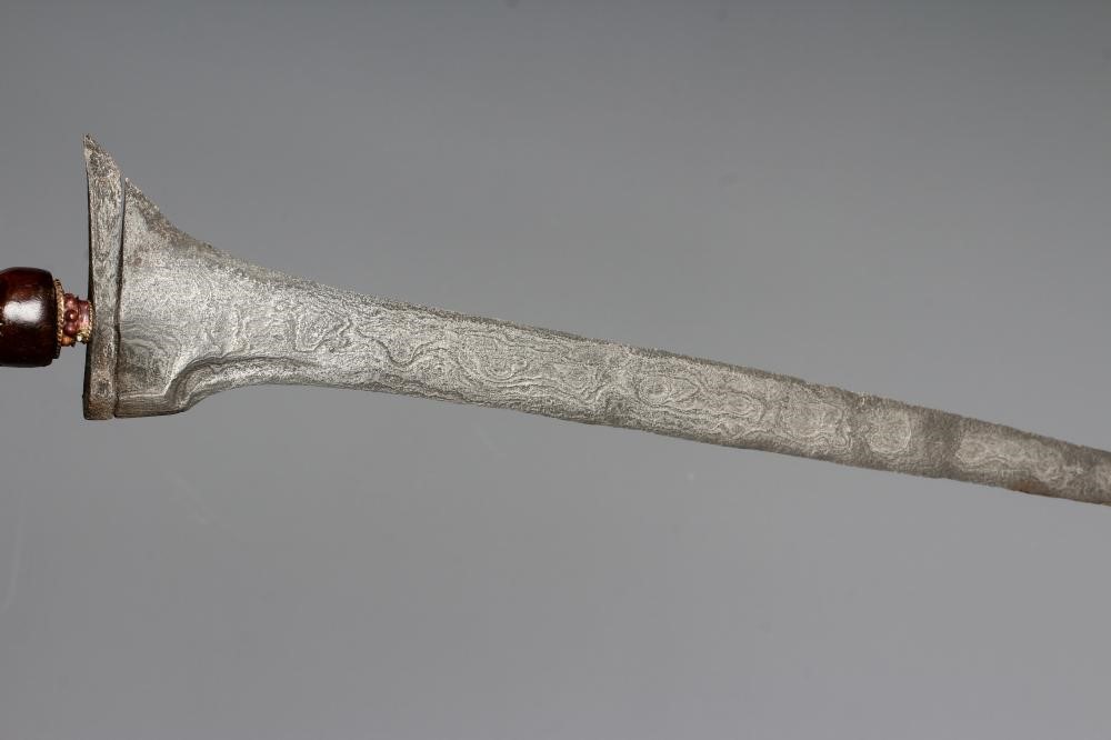 THREE INDONESIAN KRIS DAGGERS with shaped and laminated steel blades, carved grips and typical two Image