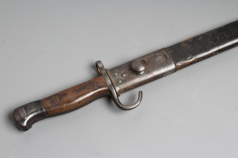 A RARE BRITISH 1907 BAYONET with hooked quillon, 17" blade, two piece wood grip, and leather Image
