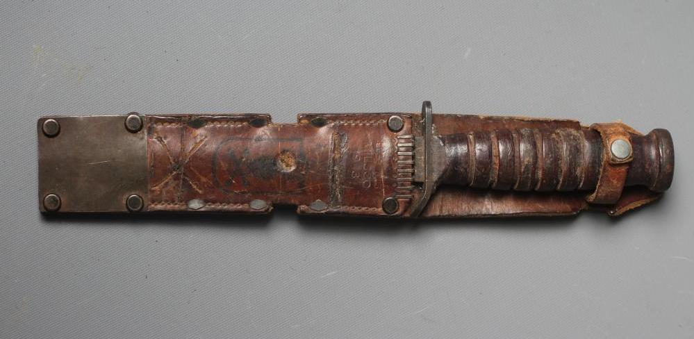 A US M3 CAMILLUS FIGHTING KNIFE with 6 5/8" spear point blade, leather sectional grip, and leather Image