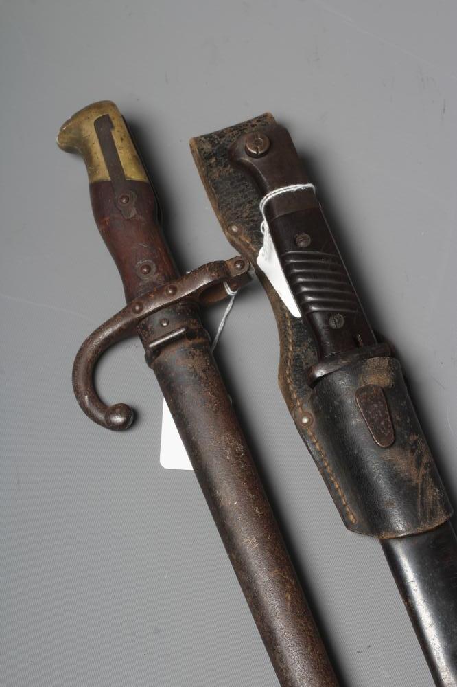 TWO BAYONETS, comprising a K98 German bayonet with steel scabbard and leather frog, and a French Image