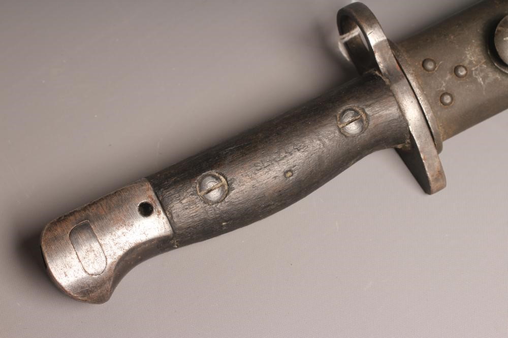 A RARE OWEN SMG BAYONET with 10" blade, two piece wood grip stamped "SLAZ44" and leather scabbard Image