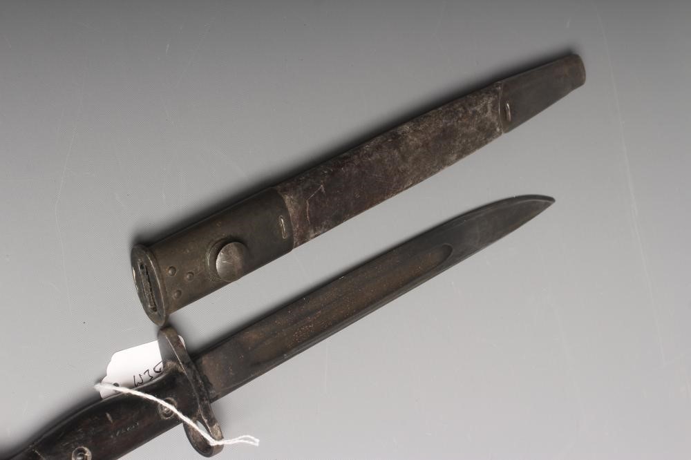 A RARE OWEN SMG BAYONET with 10" blade, two piece wood grip stamped "SLAZ44" and leather scabbard Image