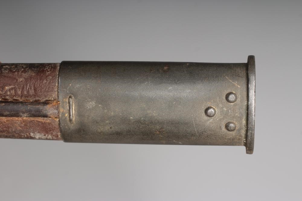 A RARE OWEN SMG BAYONET with 10" blade, two piece wood grip stamped "SLAZ44" and leather scabbard Image