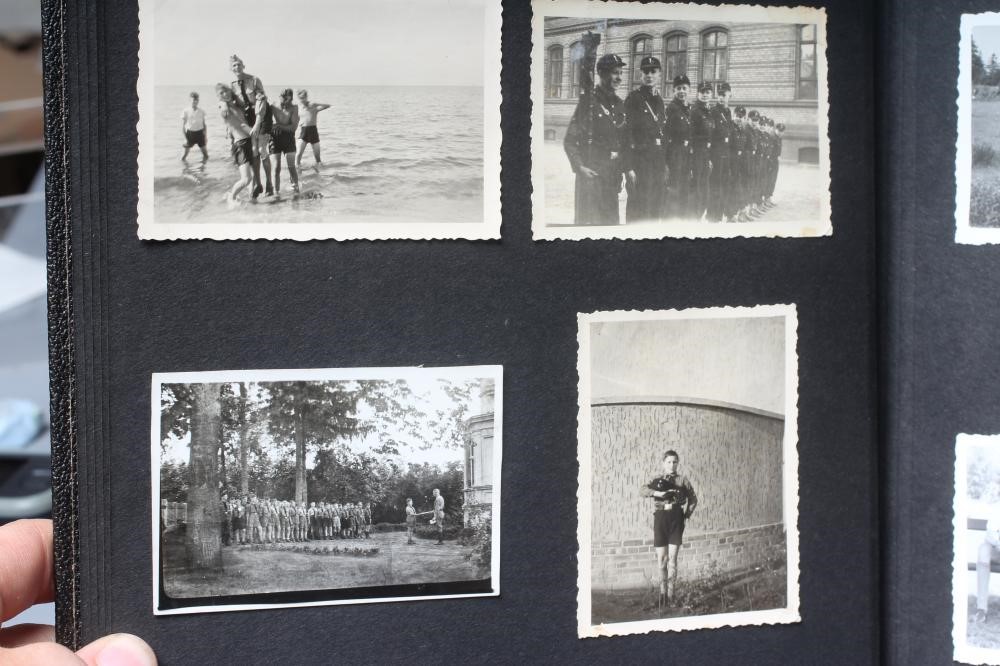 A HITLER YOUTH PHOTO ALBUM, containing 50 original images from the pre-war and war time period (Est. Image