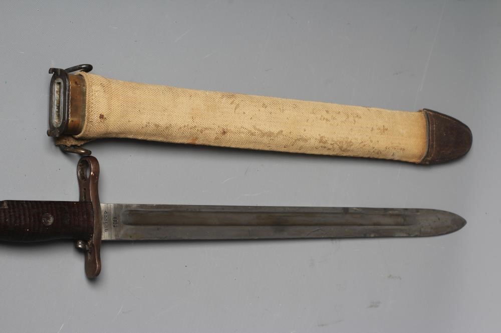 A US 1905 PATTERN SPRINGFIELD BAYONET with canvas scabbard Image
