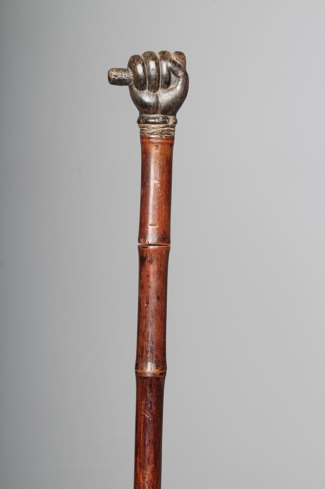 A SWAGGER SWORD STICK, 19th century, with 17 3/4" square section blade, pommel carved as a clenched Image