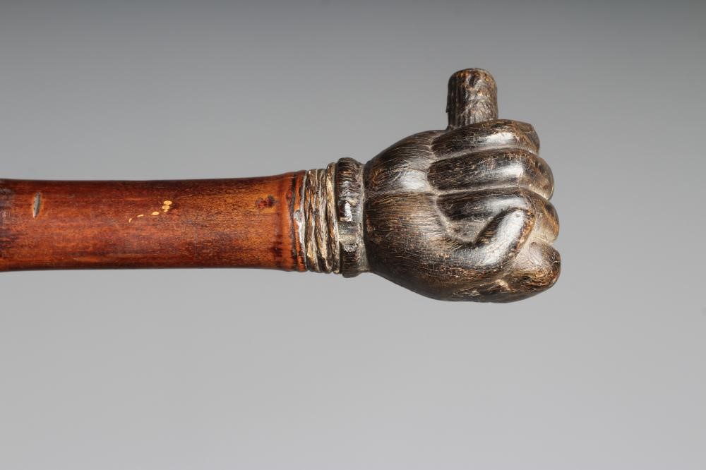 A SWAGGER SWORD STICK, 19th century, with 17 3/4" square section blade, pommel carved as a clenched Image