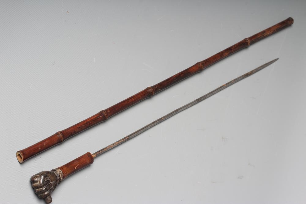 A SWAGGER SWORD STICK, 19th century, with 17 3/4" square section blade, pommel carved as a clenched Image