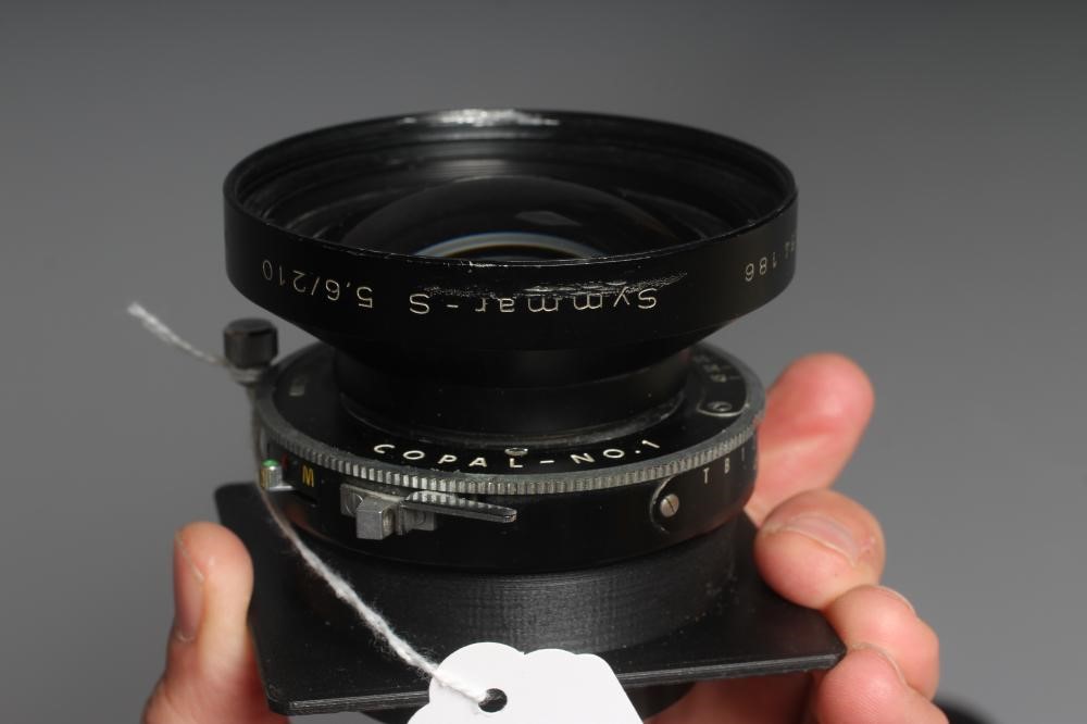 TWO CAMERA LENSES, comprising a Copal No.1 Symmar-S 5,6/210 lens, and a Fujinon SW 1:8/90 lens (Est. Image