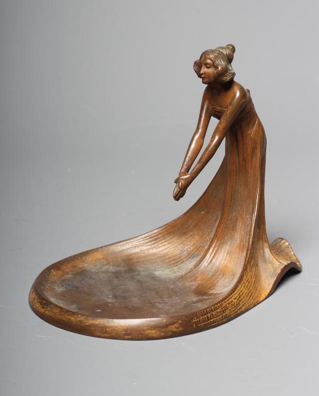 AN ART NOUVEAU PATINATED COPPER FIGURAL DISH modelled as a young lady wearing a flowing dress Image