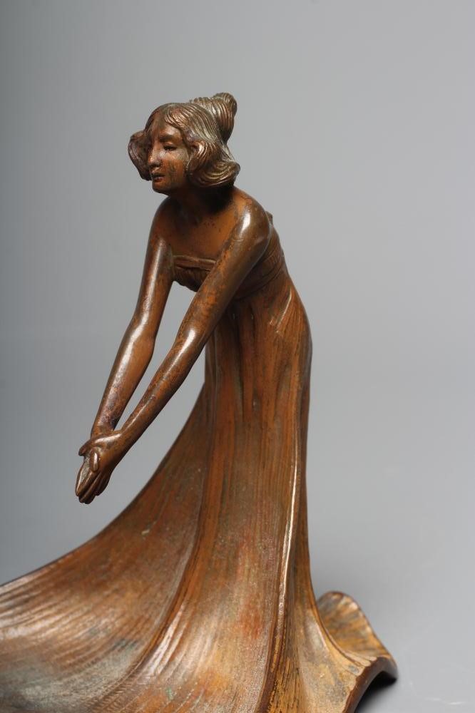 AN ART NOUVEAU PATINATED COPPER FIGURAL DISH modelled as a young lady wearing a flowing dress Image