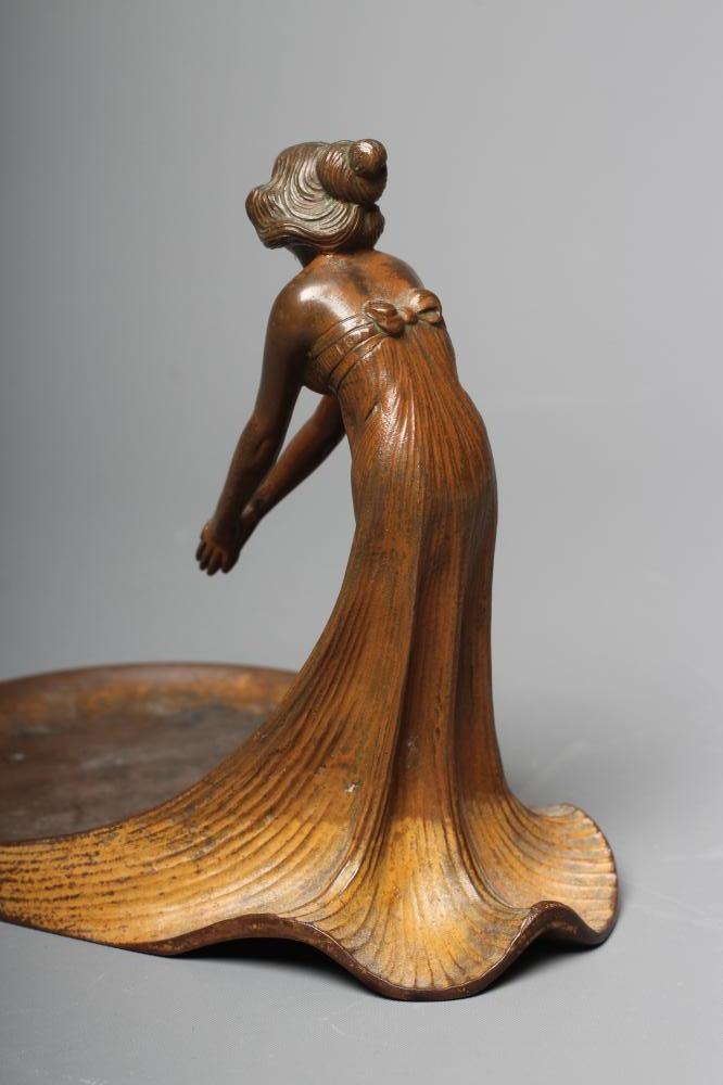 AN ART NOUVEAU PATINATED COPPER FIGURAL DISH modelled as a young lady wearing a flowing dress Image