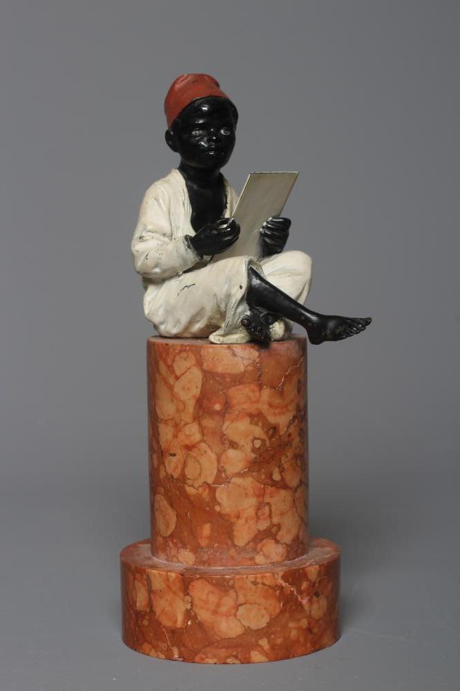 A BERGMAN COLD PAINTED BRONZE ARAB BOY, early 20th century, the boy seated and raised on a column Image