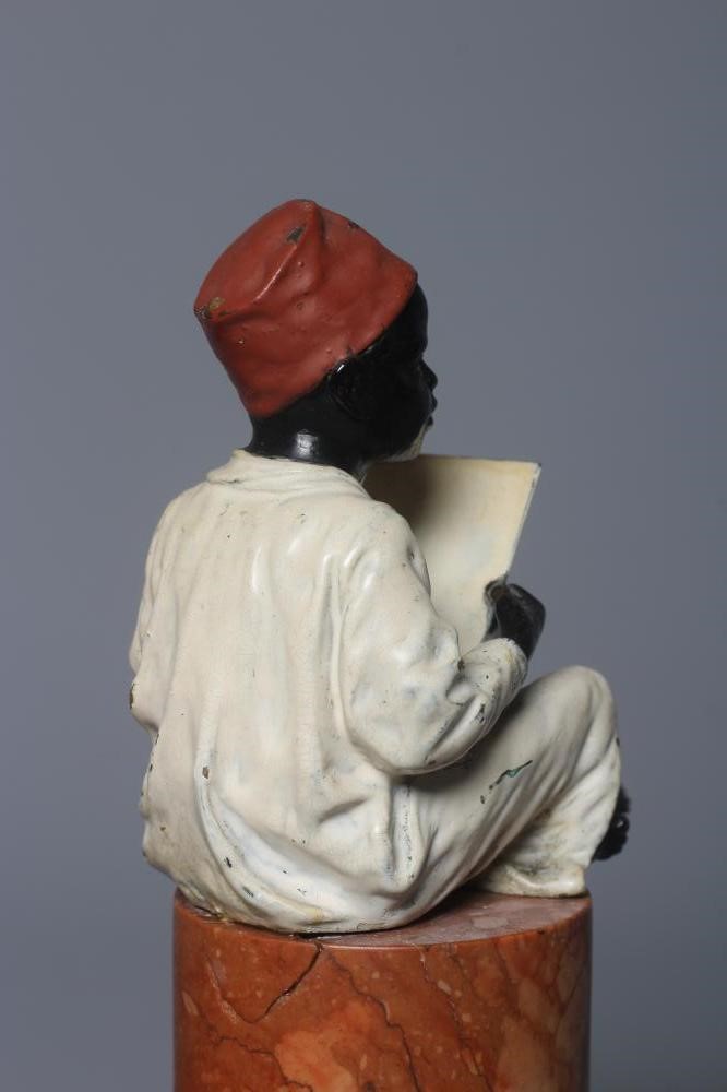A BERGMAN COLD PAINTED BRONZE ARAB BOY, early 20th century, the boy seated and raised on a column Image
