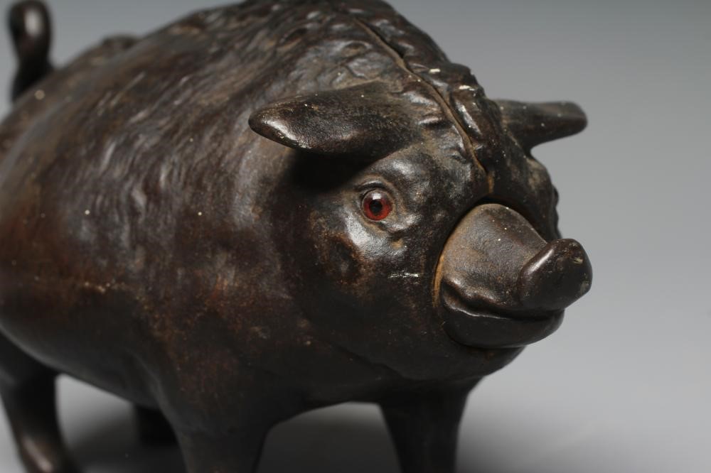 A BUTCHER'S SHOP CAST IRON PIG COUNTER BELL, late Victorian, with amber glass eyes, the clockwork Image