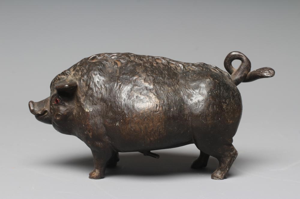 A BUTCHER'S SHOP CAST IRON PIG COUNTER BELL, late Victorian, with amber glass eyes, the clockwork Image