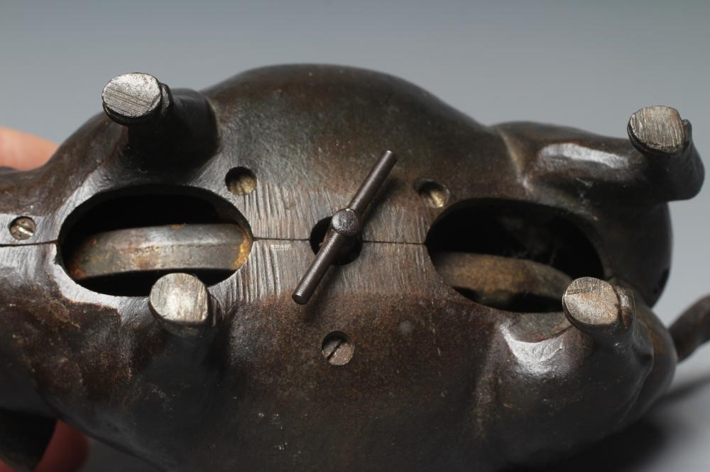 A BUTCHER'S SHOP CAST IRON PIG COUNTER BELL, late Victorian, with amber glass eyes, the clockwork Image
