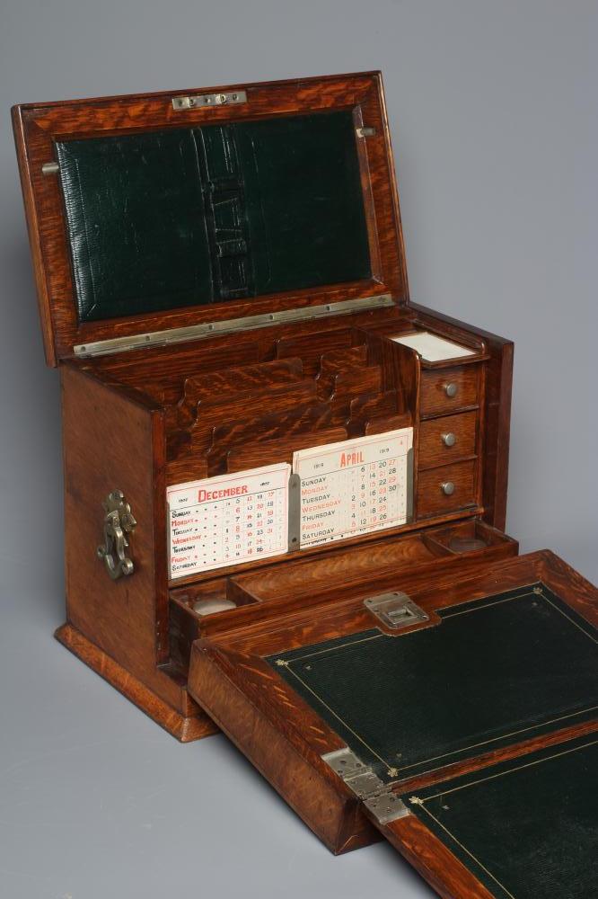 AN EDWARDIAN OAK STATIONERY BOX of oblong form with lightly domed hinged lid and two brass handles Image