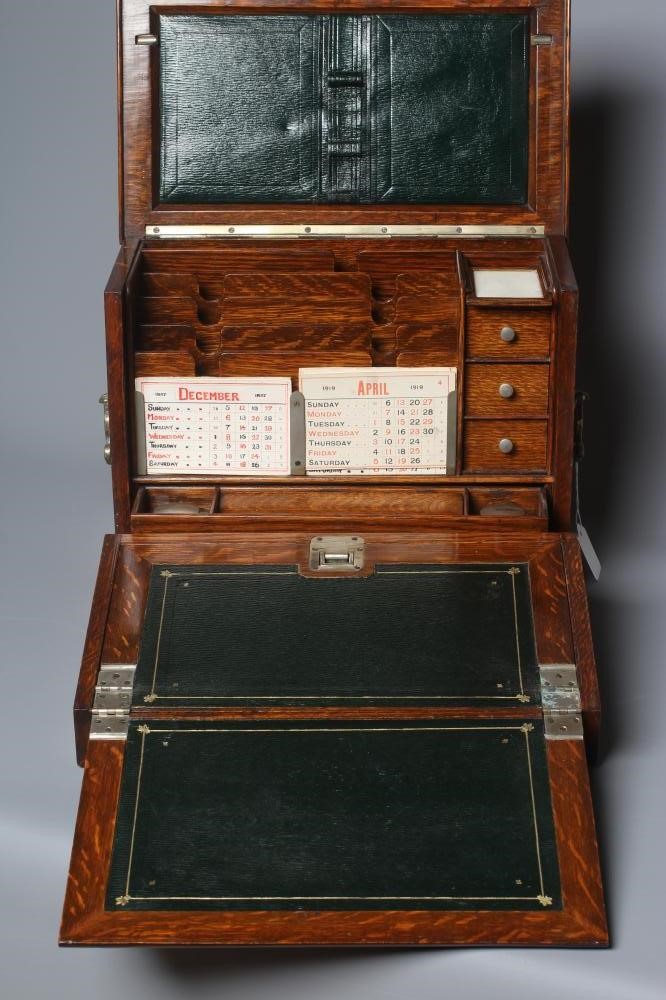 AN EDWARDIAN OAK STATIONERY BOX of oblong form with lightly domed hinged lid and two brass handles Image