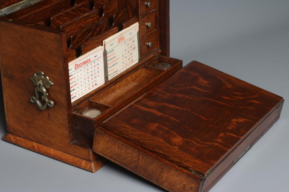 AN EDWARDIAN OAK STATIONERY BOX of oblong form with lightly domed hinged lid and two brass handles Image