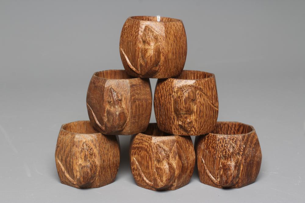 A SET OF SIX ROBERT THOMPSON OCTAGONAL NAPKIN RINGS each with carved mouse trademark, approximately Image