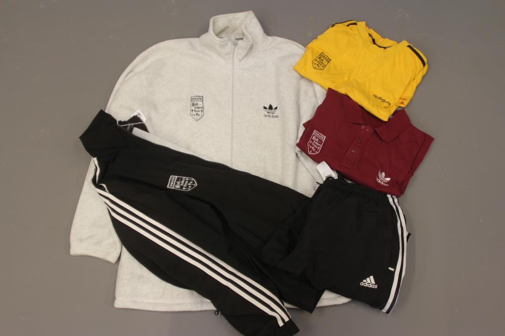 A BESPOKE ADIDAS BOLT MAKERS ARMS PUB FOOTBALL TEAM SPORTS KIT comprising of a black track suit top Image