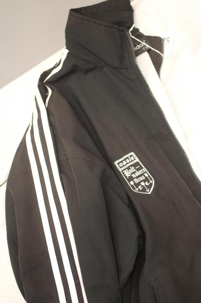 A BESPOKE ADIDAS BOLT MAKERS ARMS PUB FOOTBALL TEAM SPORTS KIT comprising of a black track suit top Image