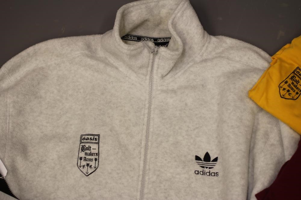 A BESPOKE ADIDAS BOLT MAKERS ARMS PUB FOOTBALL TEAM SPORTS KIT comprising of a black track suit top Image