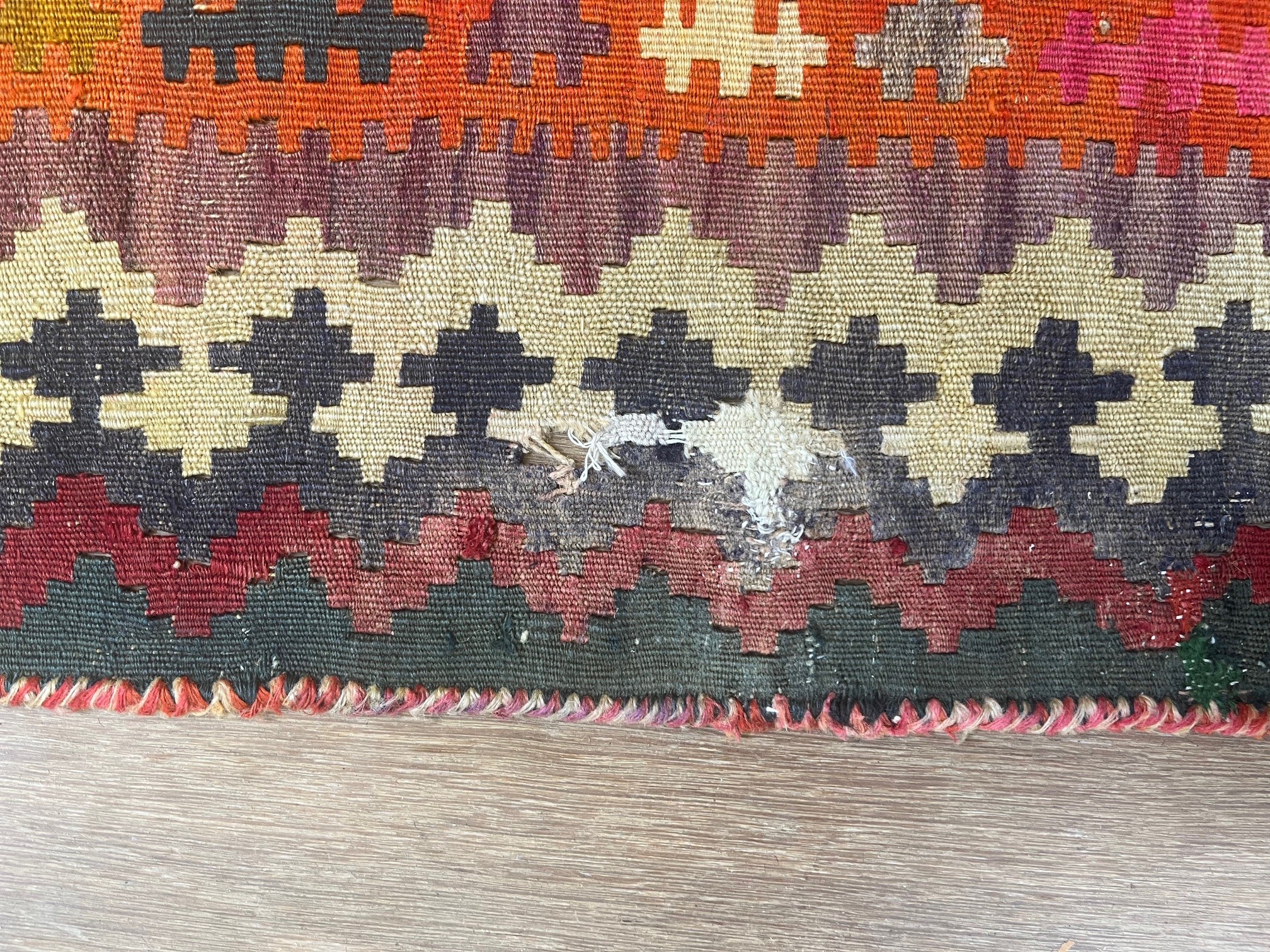 A TURKISH KILIM, latter half 20th century, the red field with repeating polychrome gul pattern Image