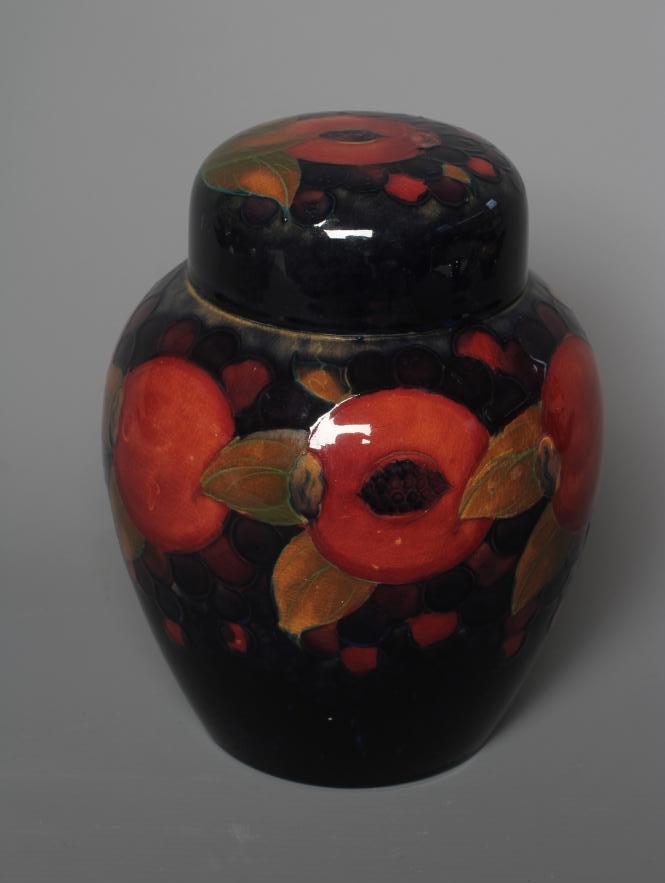 A MOORCROFT POTTERY POMEGRANATE PATTERN JAR AND COVER Image