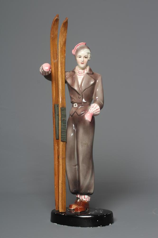 AN ART DECO KATZHUTTE EARTHENWARE FIGURE modelled as a young female skier wearing a brown trouser Image