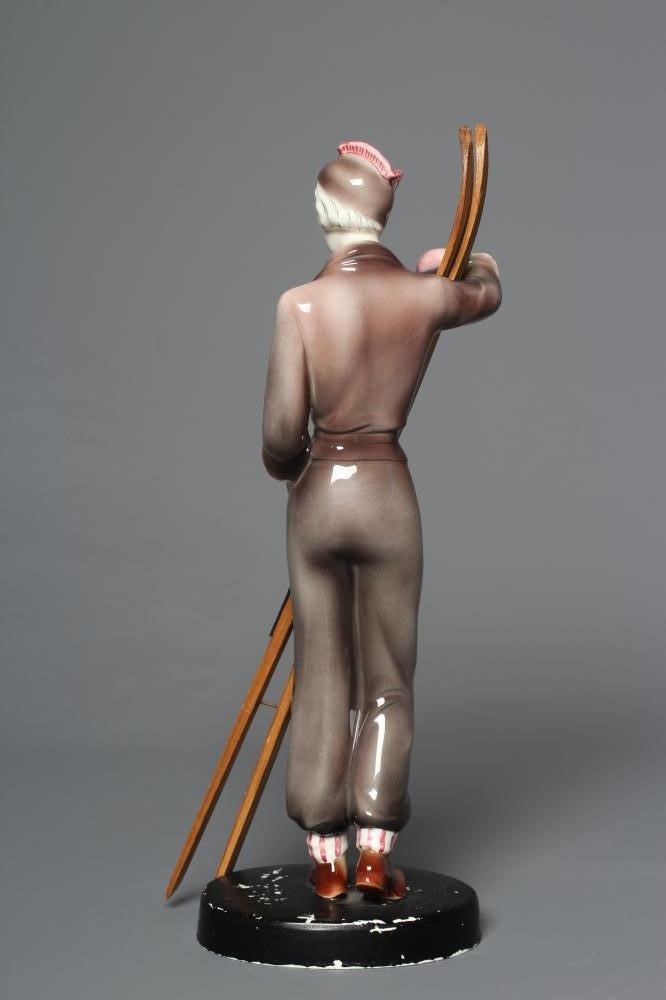 AN ART DECO KATZHUTTE EARTHENWARE FIGURE modelled as a young female skier wearing a brown trouser Image