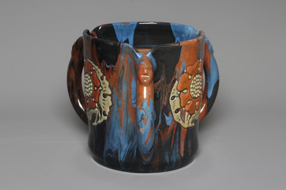 A LATE VICTORIAN ELTONWARE LARGE CYLINDRICAL TYG slip decorated in browns, green and blues with Image
