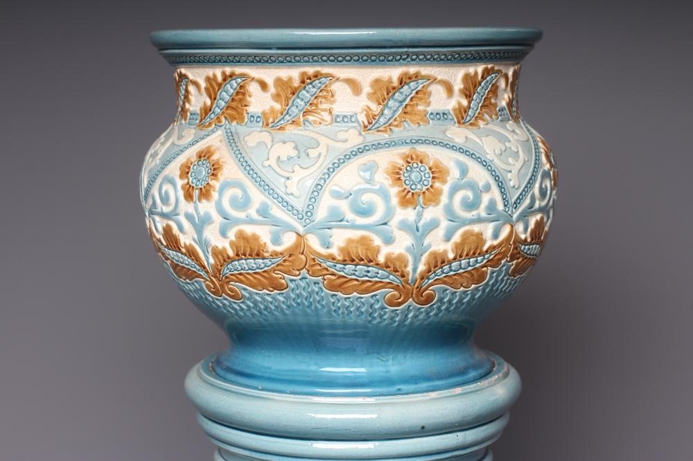 A BURMANTOFTS FAIENCE SMALL JARDINIERE AND STAND moulded and impressed with stylised flowers Image