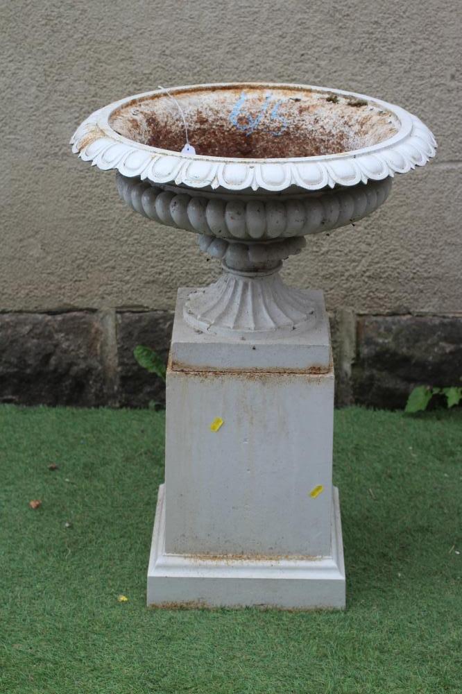 A CAST IRON CAMPANA URN ON STAND, the shallow half fluted bowl with ovolo rim and fluted socle, Image