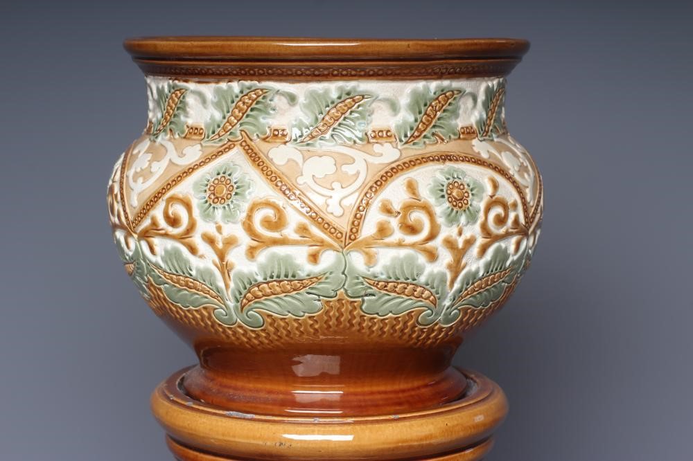 A BURMANTOFTS FAIENCE SMALL JARDINIERE AND STAND moulded and impressed with stylised flowers Image