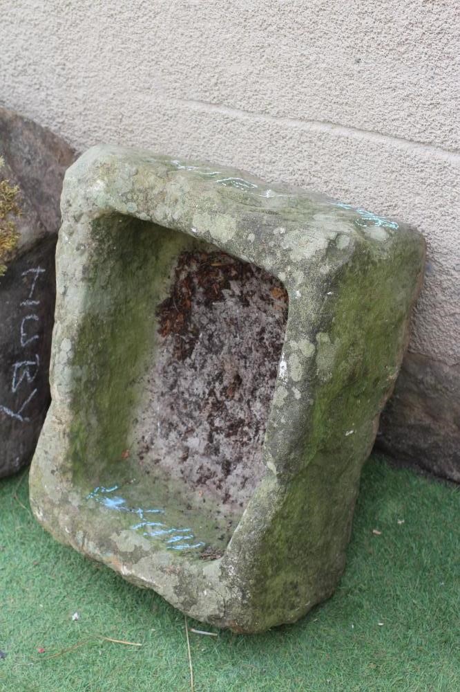A SANDSTONE TROUGH of rough hewn tapering oblong form, 20 1/2" w x 17" d x 8 1/2" h, together with a Image
