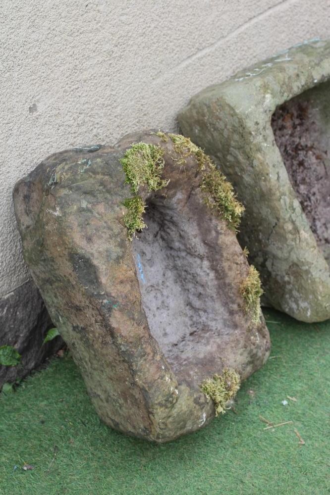 A SANDSTONE TROUGH of rough hewn tapering oblong form, 20 1/2" w x 17" d x 8 1/2" h, together with a Image