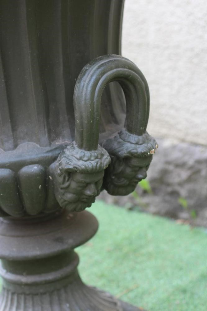 A VICTORIAN CAST IRON URN, late 19th century, of fluted campana form with ovolo rim, reeded mask Image
