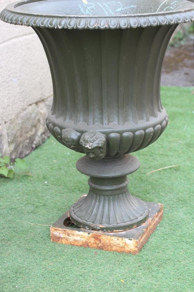 A VICTORIAN CAST IRON URN, late 19th century, of fluted campana form with ovolo rim, reeded mask Image