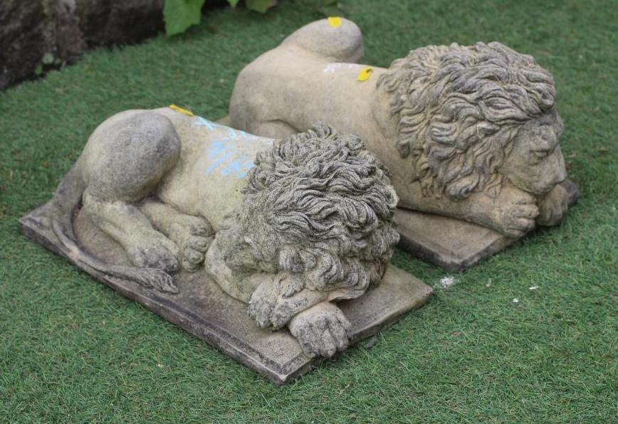 A PAIR OF CAST STONE RECUMBENT LIONS, after Antonio Canova, each on oblong base, 15 1/2" w x 9" d x Image