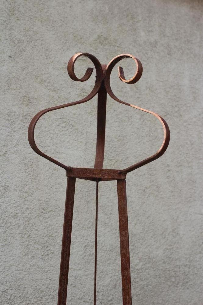 A HAND FORGED WROUGHT IRON TRIANGULAR PLANT SUPPORT with scrolled finial, 13 1/4" w x 91 1/4" h Image