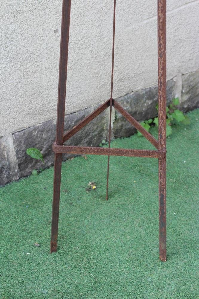 A HAND FORGED WROUGHT IRON TRIANGULAR PLANT SUPPORT with scrolled finial, 13 1/4" w x 91 1/4" h Image
