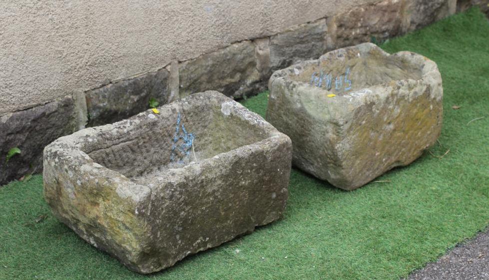 A SANDSTONE TROUGH of rough hewn oblong form, 24" w x 13 1/2" d x 11" h, together with a similar Image