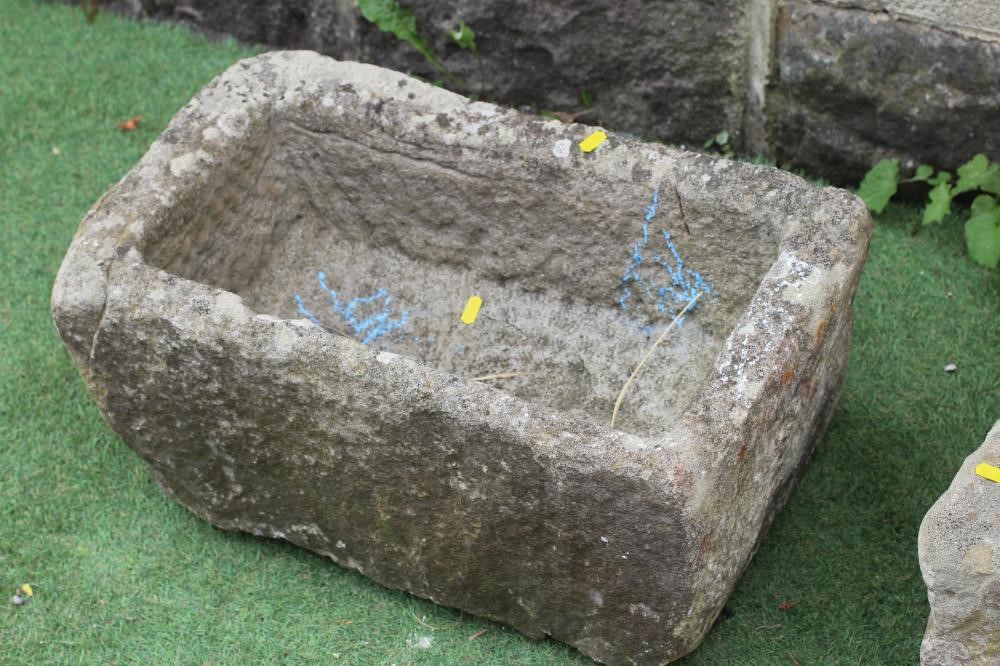A SANDSTONE TROUGH of rough hewn oblong form, 24" w x 13 1/2" d x 11" h, together with a similar Image