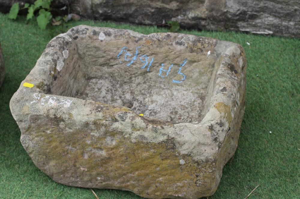 A SANDSTONE TROUGH of rough hewn oblong form, 24" w x 13 1/2" d x 11" h, together with a similar Image