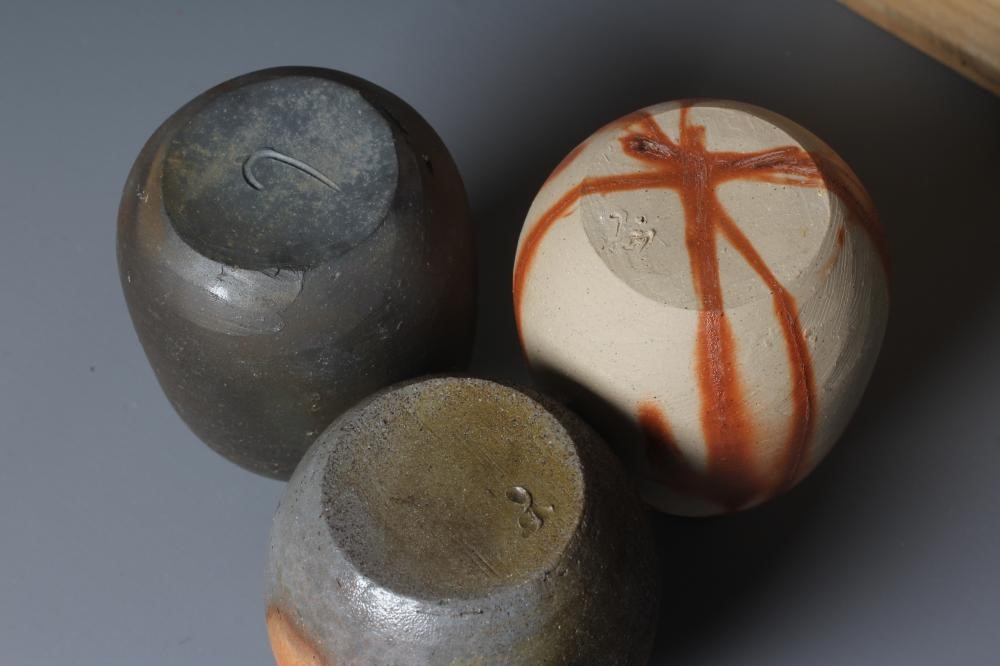THREE BIZEN STONEWARE TOKKURI, one with a hidasuki firing, various incised marks, one possibly by Image