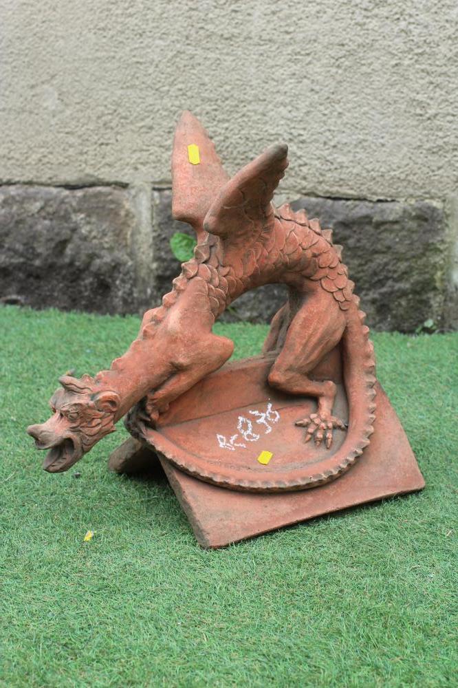 A TERRACOTTA DRAGON ROOF RIDGE FINIAL, mounted on a triangular base, 17 3/4" w x 16 1/2" d (Est. Image
