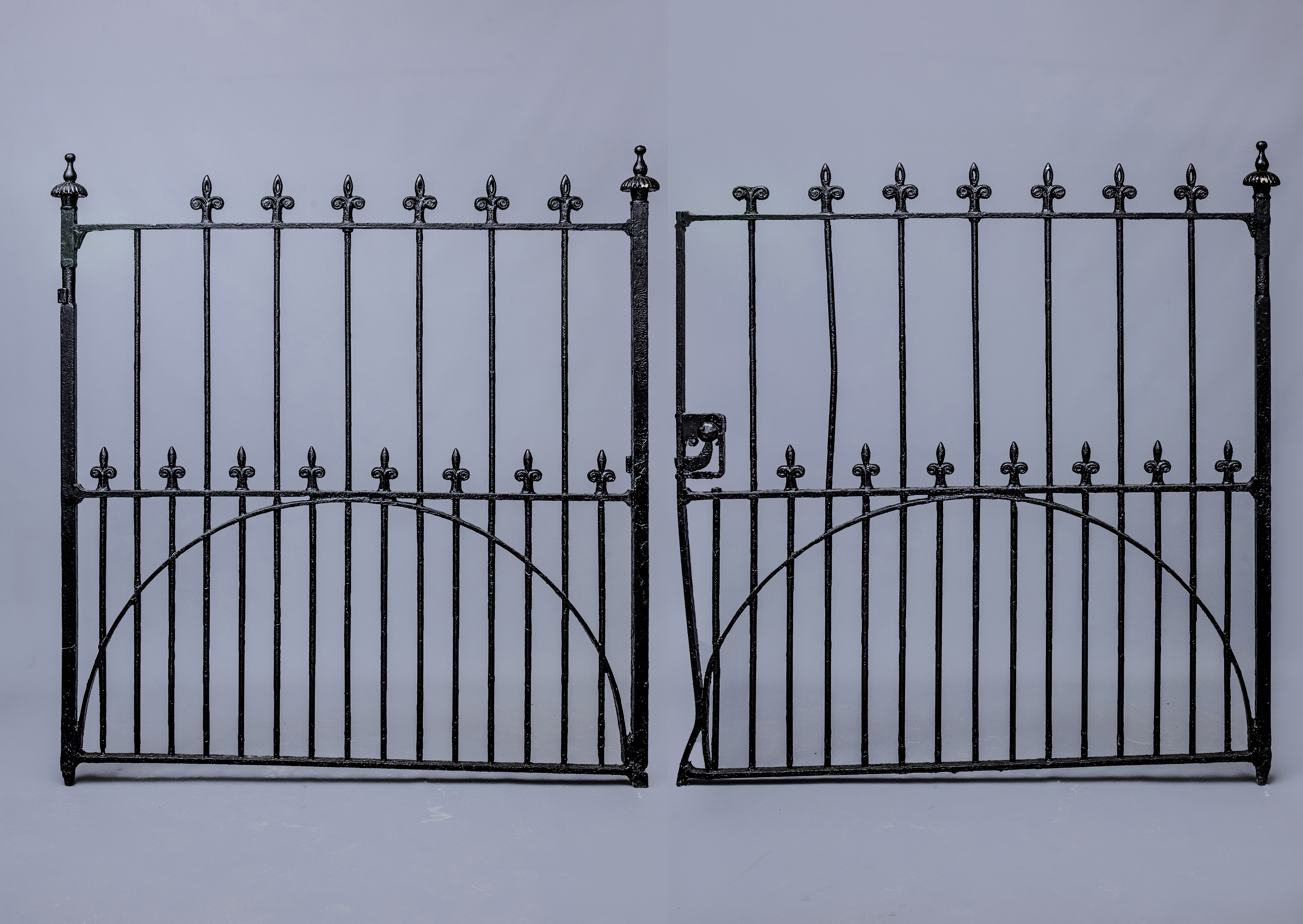 A PAIR OF VICTORIAN CAST AND WROUGHT IRON VEHICULAR ENTRANCE GATES of barred form with fleur-de-lys Image