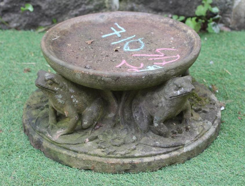 A CAST STONE BIRDBATH, the circular bowl raised on three frog supports, the mildly domed circular Image